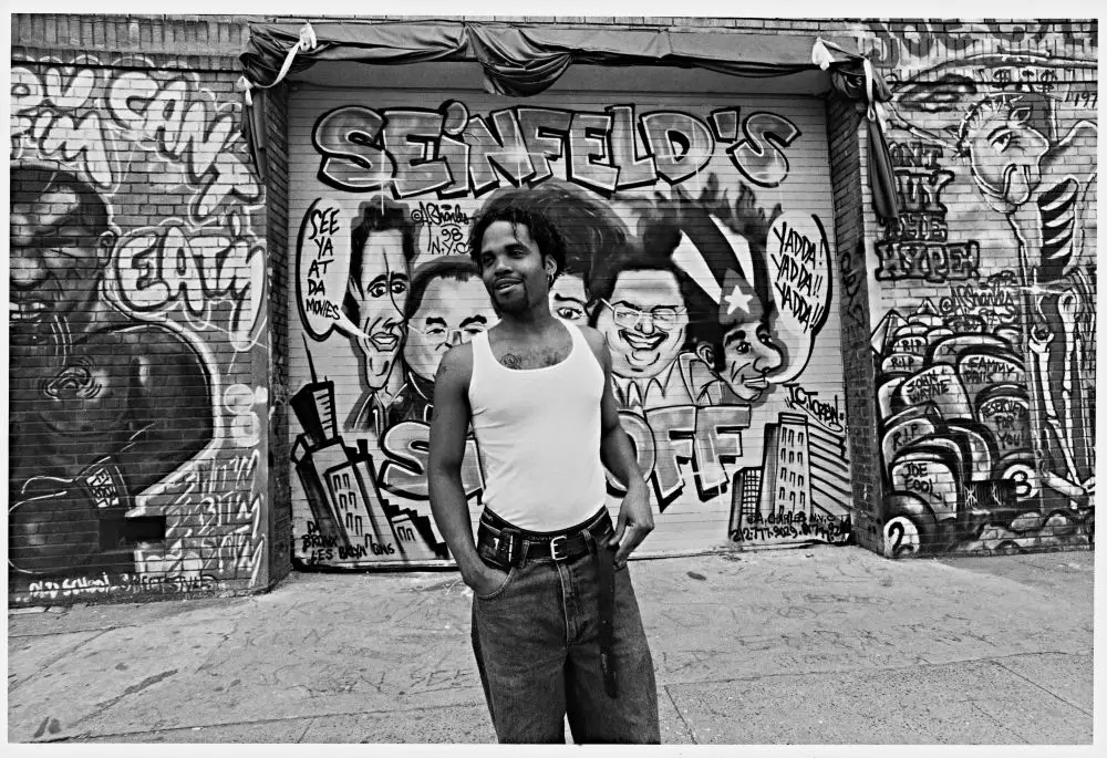 Andre Charles, graffiti artist in front of some of his work, Houston Street, New York, USA, 1998.jpg