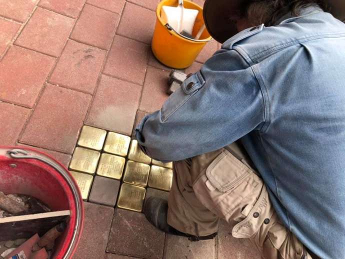 Artist Gunther Demnig laying some of the Stolpersteine