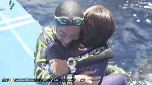 Alessia Zecchini and Alenka Artnik hug after their successful dives