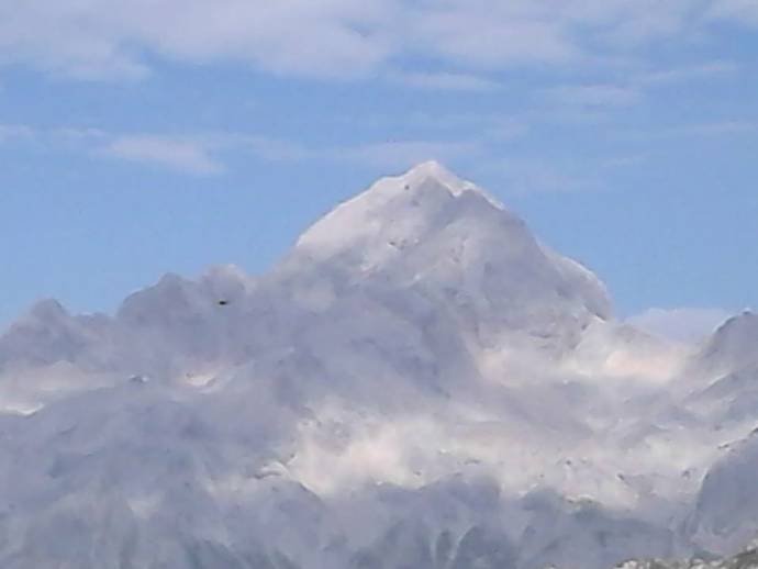 Triglav slikan z Viševnika. Igra Sonca in Oblakov