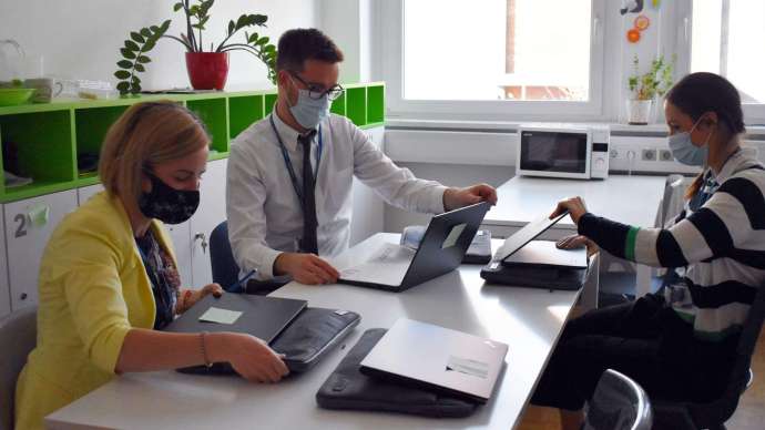 Staff using the laptops at school in their first training sessions